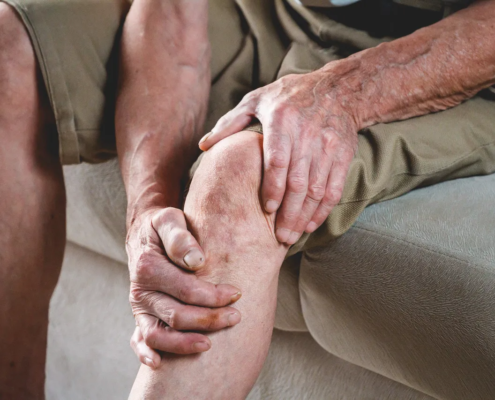 Elderly senior massaging his legs due to pain